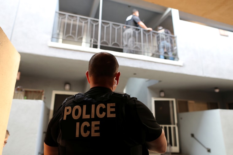 A U.S. Immigration and Customs Enforcement (ICE) officer at a home in Hawthorne, Calif.