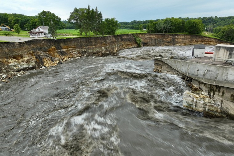 Floodwater continues to carve a channel around the Rapidan Dam,  near Mankato, Minn.