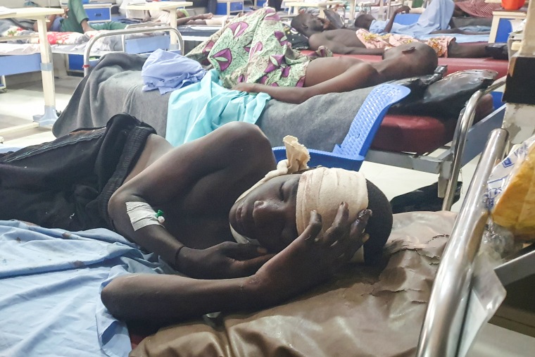 Injured people lay on hospital beds