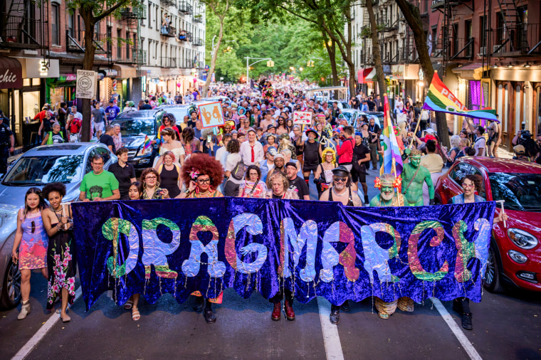 Participants seen holding a banner at the march that says "Drag March"