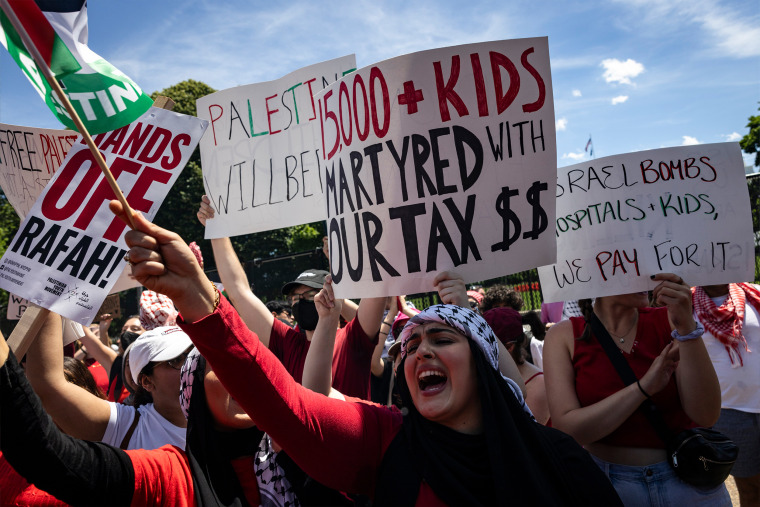 Pro-Palestinian activists hold up signs and chant on Pennsylvania Avenue in front of the White House during a demonstration protesting the war in Gaza on Saturday in Washington, D.C. 
