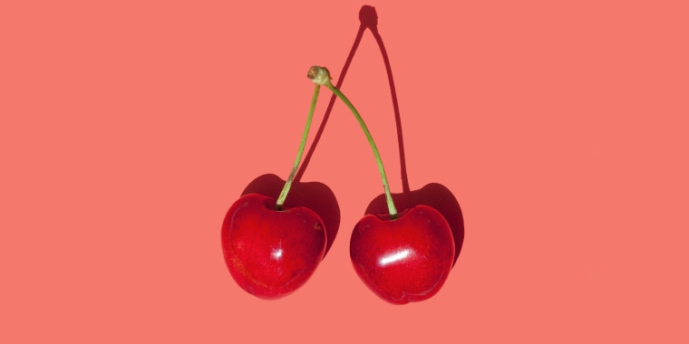 Cherry fruit isolated on red background