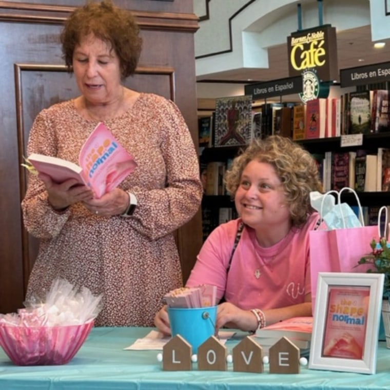 Cathy reading from her book with Jessica during a book launch