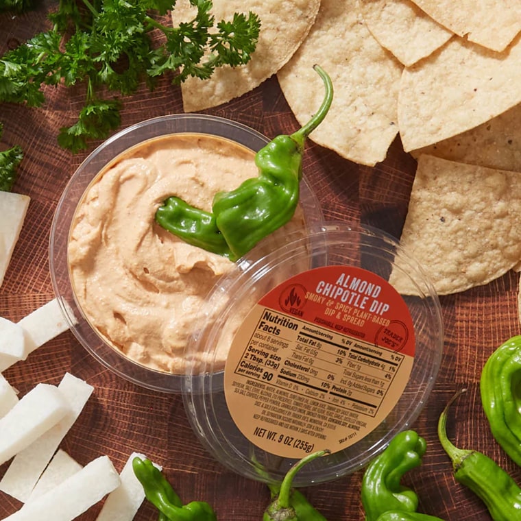 Trader Joe's Almond Chipotle Dip; in center, surrounded by tortilla chips, jicama sticks, shisishto peppers and parsley garnish
