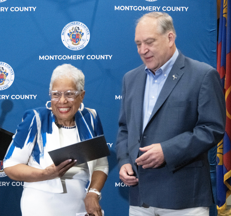 Emma Patterson receiving her award from Montgomery County Executive Marc Elrich.