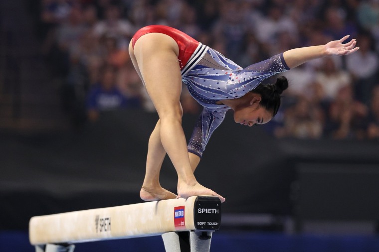 Suni Lee stumbles while competing on the balance beam.