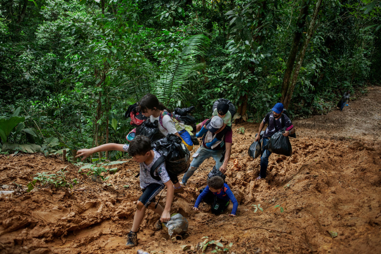 A family walks through the mud