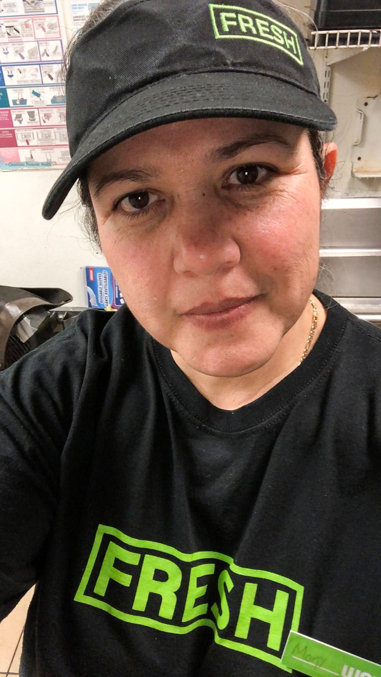 A selfie of Monica Ramirez wearing a black cap and shirt that both say "Fresh" in green lettering