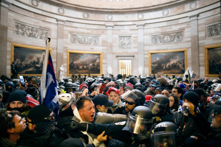 Rioters and police inside the Capitol