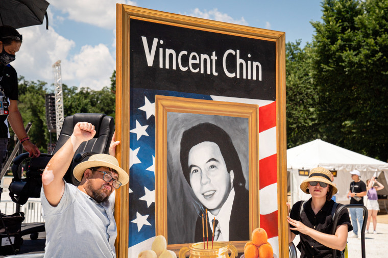Demonstrators hold a mural of Vincent Chin.