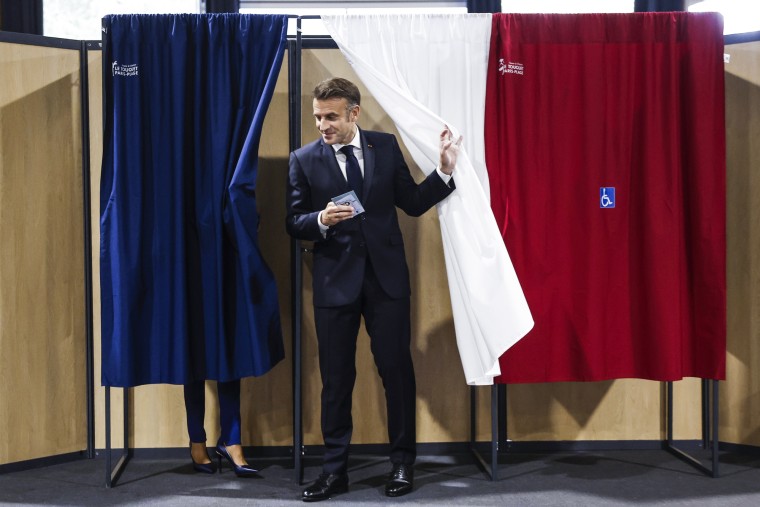 Emmanuel Macron exits a polling booth