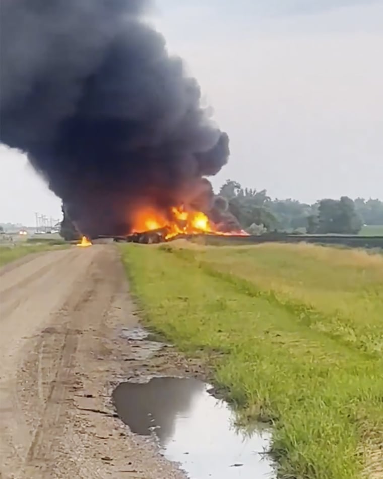 Rail cars containing hazardous material derailed and burst into flames early Friday in a remote area of North Dakota, but emergency officials say no one was hurt and the threat to those living nearby appears to be minimal. 