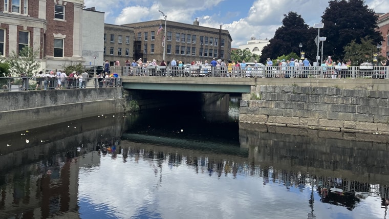 Attendees dropped flowers into the Kenduskeag Stream bridge where Howard was killed.