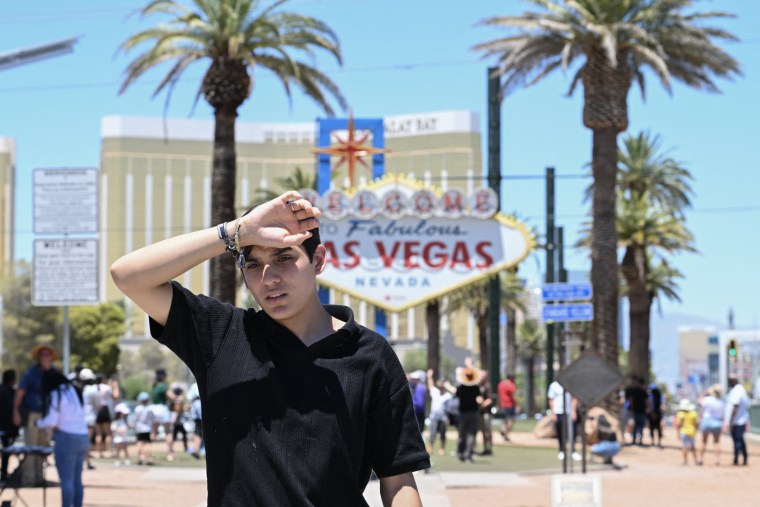 A man walks near the Las Vegas strip during a heat wave in Las Vegas on July 7, 2024. 