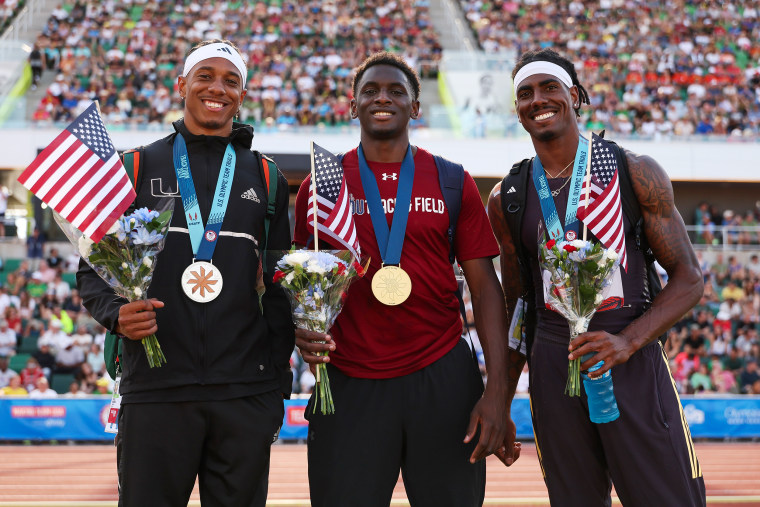 Russell Robinson, Salif Mane, and Donald Scott pose with their medals