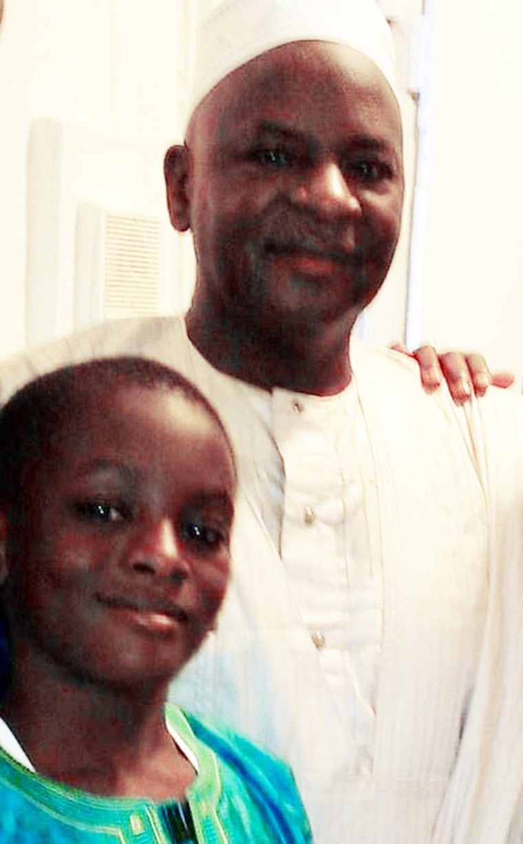 Salif Mane as a child poses for a photo with his father