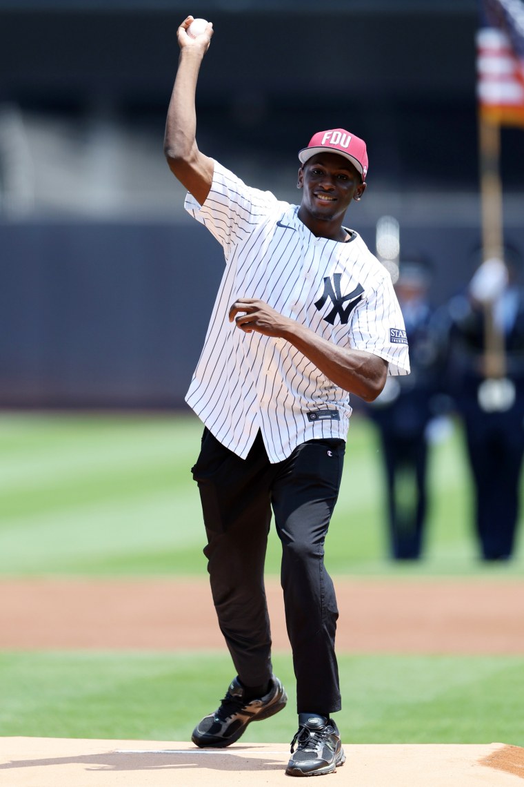 Salif Mane smiles as he throw the baseball