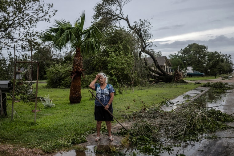 Woman grieves tree uprooted by Hurricane Beryl in Freeport, Texas