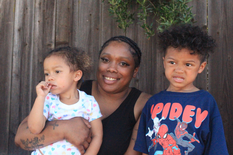 Diola Lucero and her children outside their preschool.