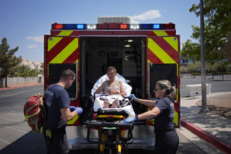 Members of the Henderson Fire Department load Deb Billet, 66, into an ambulance before transporting her to the hospital for heat-related symptoms, Wednesday, July 10, 2024, in Henderson, Nev. Billet has been living on the streets.