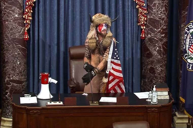 Jacob Chansley, also known as the QAnon Shaman, screams inside the U.S. Senate chamber in Washington, DC on Jan. 6, 2021. 