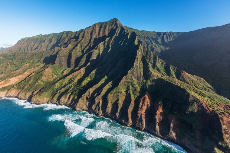 Pacific Ocean waves break on the Na Pali Cliffs in the Na Pali Coast State Park on Kauai, Hawaii