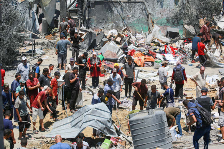 Palestinians look for loved ones in the debris of tents and make shift homes.