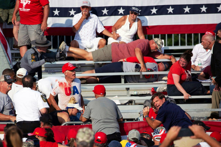 Attendees some covered in blood lie in the stands