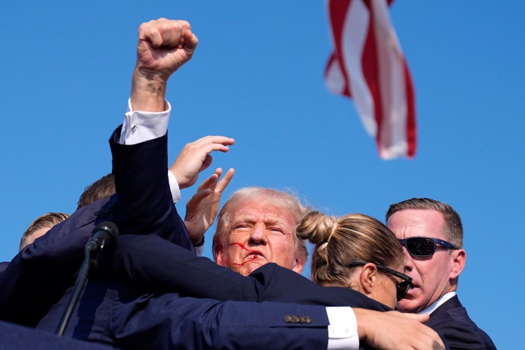 Donald Trump surrounded by U.S. Secret Service agents at a campaign rally Saturday.