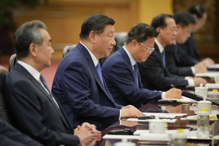 China's President Xi Jinping, second from left, attends a meeting at the Great Hall of the People in Beijing on July 12, 2024.