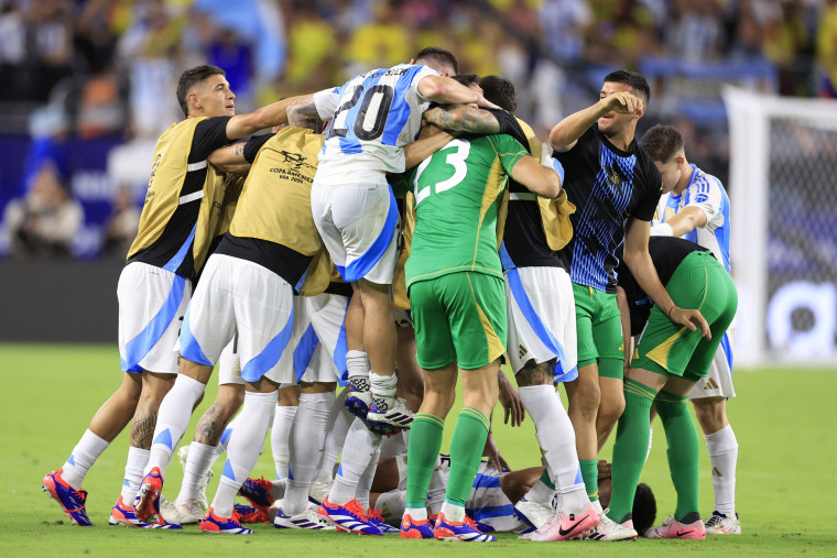 Lautaro Martinez of Argentina celebrates with teammates after scoring the team's first goal during the Copa America 2024 final match between Argentina and Colombia.