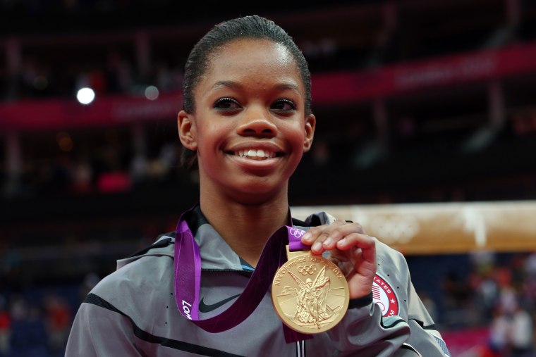 Gabrielle Douglas of the United States celebrates on the podium after winning the gold medal in the Artistic Gymnastics Women's Individual All-Around final on Day 6 of the London 2012 Olympic Games at North Greenwich Arena on August 2, 2012 in London.