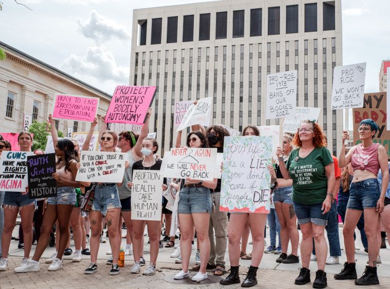 Protesters hold signs at a pro abortion rights rally, in Dayton, Ohio