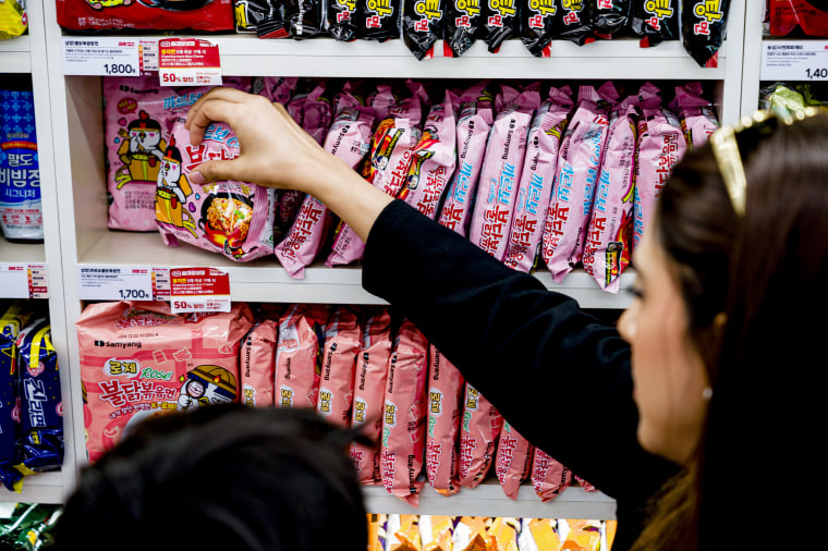 Tourists picks out varieties of the Buldak Samyang instant noodles from the store shelf. 