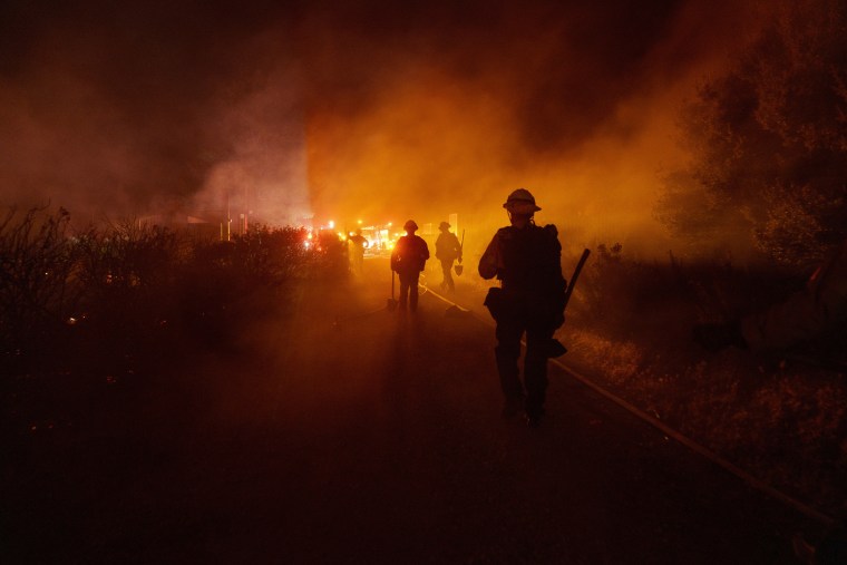 Firefighters work against the advancing Post Fire in Gorman, Calif.