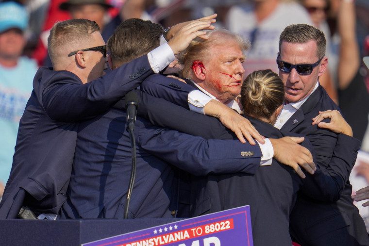 Donald Trump is surrounded by U.S. Secret Service agents.