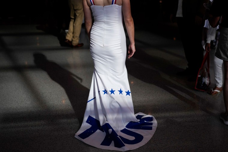 A delegate wears a gown that says Trump 