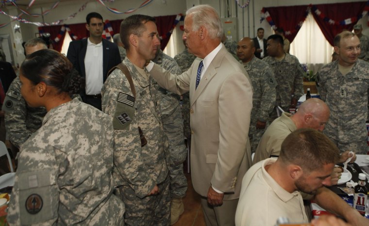 Then-Vice President Joe Biden speaks with one of his sons, Army Capt. Beau Biden, in Baghdad on July 4, 2009. 