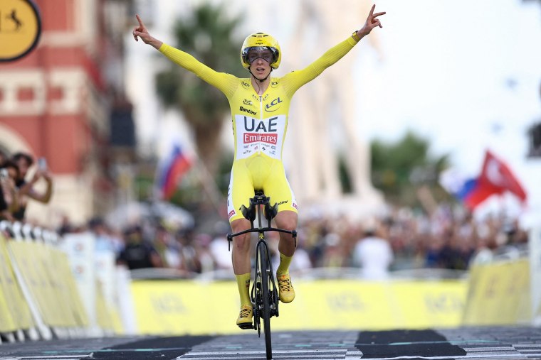 Tadej Pogacar celebrates as he crosses the finish line to win the 21st stage and overall victory of the 2024 Tour de France.