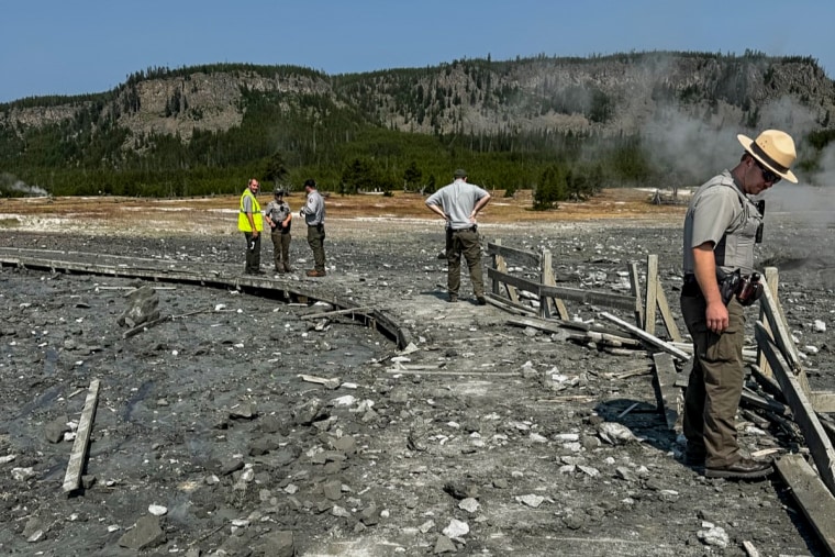Park staff assess the damage to Biscuit Basin boardwalks after hydrothermal explosion in Yellowstone National Park.