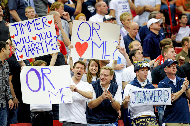 Fans of Jimmer Fredette hold up signs.