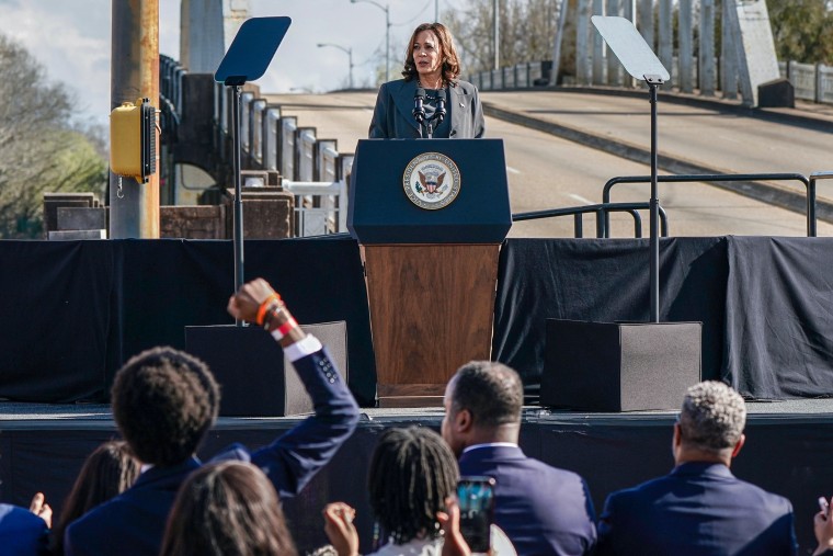 Kamala Harris speaks as Tennessee state Rep. Justin Pearson pumps his fist.