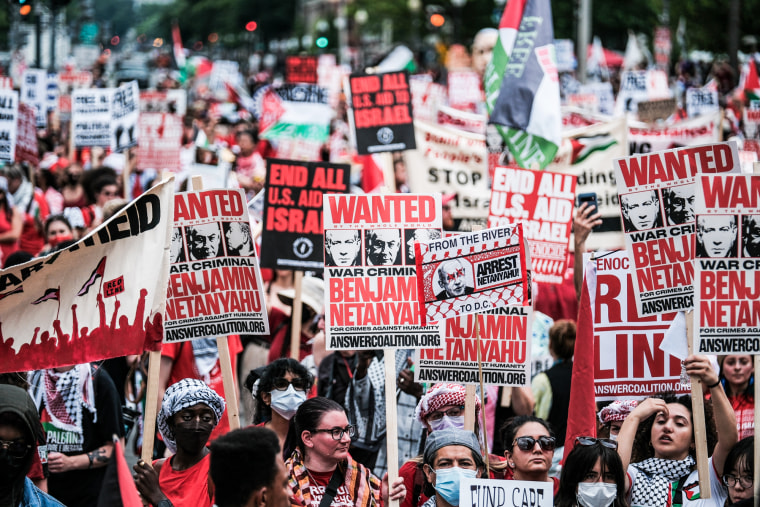 A large crowd of activists demonstrate and hold signs