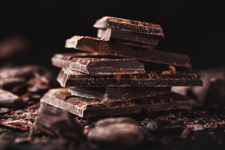 Closeup of dark chocolate chunks on table.