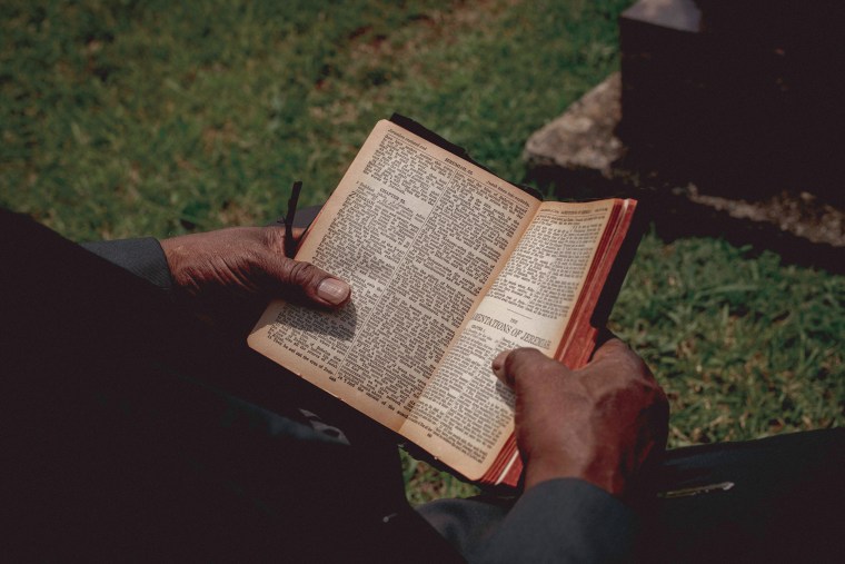 Terry Belk holds a copy of the Bible