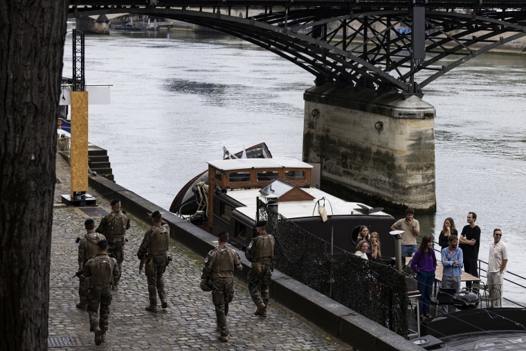 A military patrol walks along the banks of the Seine before the opening ceremony of the Paris 2024 Olympic Games, in Paris, July 26, 2024. 