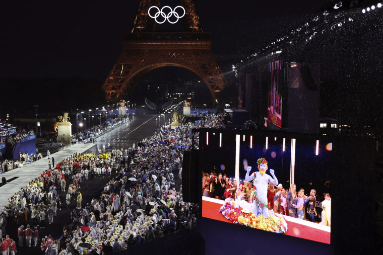 Spectators watch French singer Philippe Katerine performing during the opening ceremony of the 2024 Paris Olympics on July 26, 2024.