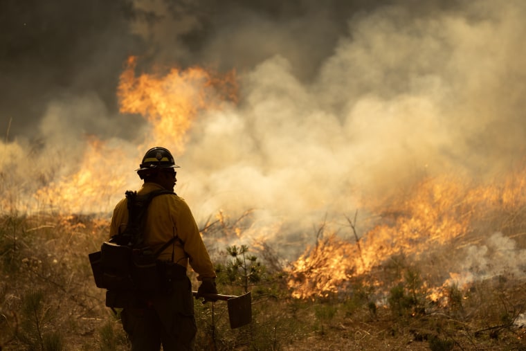 Firefighters set a backfire on the eastern front of the Park Fire