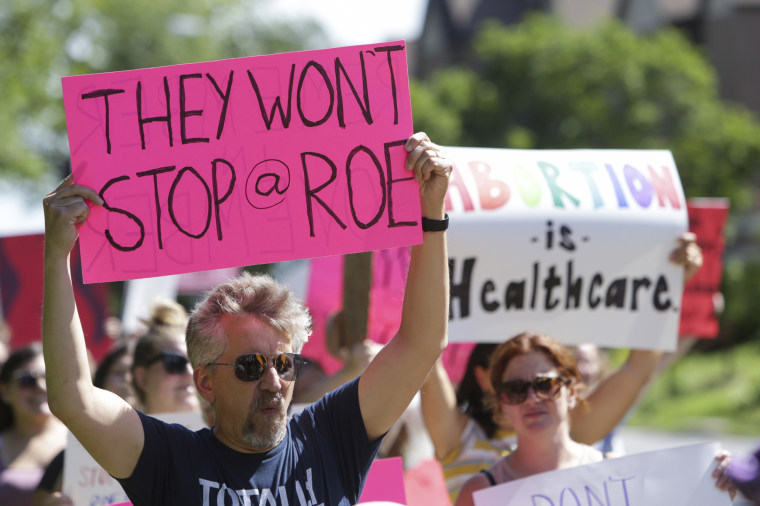 Protesters march after the Supreme Court's decision to overturn Roe v. Wade, June 26, 2022, in Davenport, Iowa. 