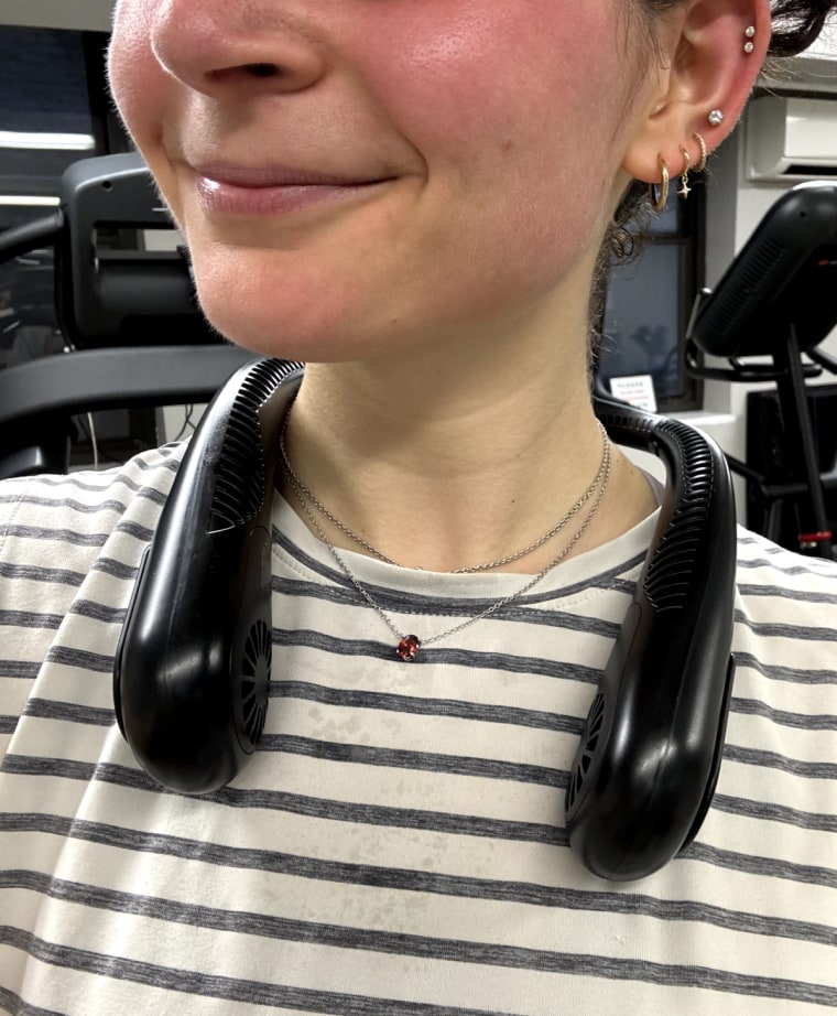 Woman in gym wearing a black neck fan